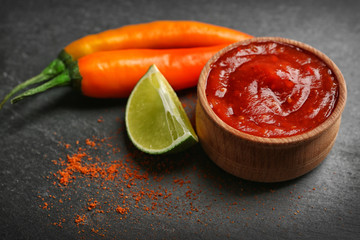 Wall Mural - Homemade hot sauce and spices on dark  background