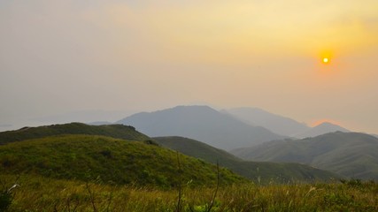 Wall Mural - Timelapse Sunset over the Forested Mountains in hongkong