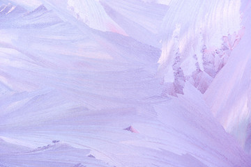 frost patterns on window glass in winter. frosted glass texture. blue purple