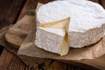 Wall Mural - Creamy Camembert on wooden background