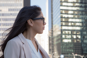 Young latin professional woman with glasses in the city