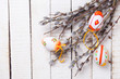 Decorative Eeaster eggs and willow branches on wooden background