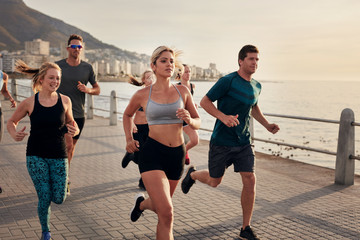 Wall Mural - Group of young people doing running workout