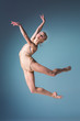 © master1305 - Young beautiful modern style dancer jumping on a studio background
