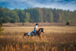 Girl riding on the red-and-white Appaloosa horse