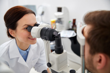 Canvas Print - optician with tonometer and patient at eye clinic