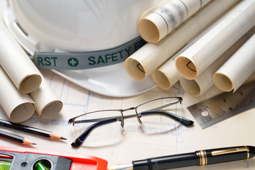 Wall Mural - Businessman eyeglasses with construction plans at construction site