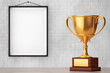 Golden Trophy in front of Brick Wall with Blank Frame