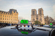 Parisien taxi with Notre Dame cathedral
