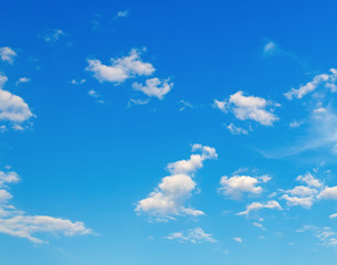 Blue sky background with a few white clouds.