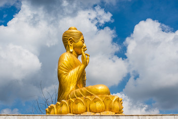 Gold Buddha Statue on blue sky background 