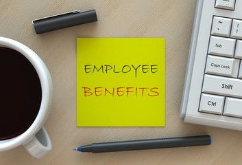 EMPLOYEE BENEFITS, message on business note paper, computer and coffee on table