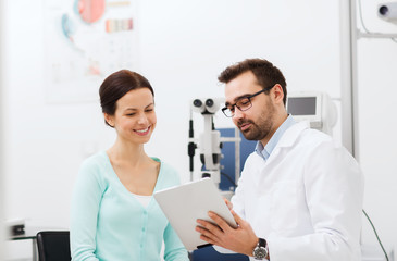 optician with tablet pc and patient at eye clinic