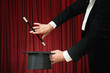 Abracadabra. Professional stage magician performing with top hat and magic wand