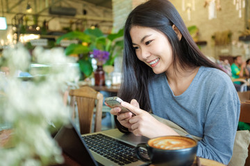 Business smiling woman use cellphone and working on Laptop