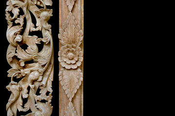 Thai wood carving of flowers on a black background