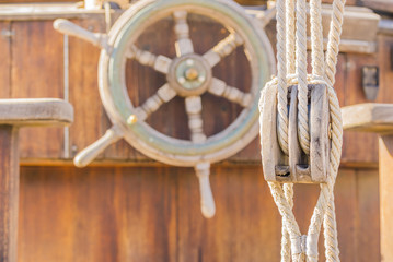 Wall Mural - Steering wheel and pulley on a old sailing boat