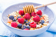 Bowl with cereals and berries healthy breakfast background.