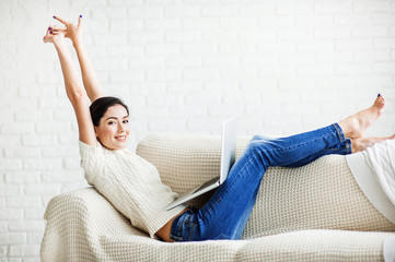 Young beautiful woman using a laptop computer at home