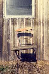 old chair on a rustic wooden wall