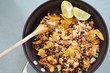 Vegan tofu scramble chilaquiles with beans, scallions and lime