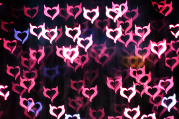 Wall Mural - Blurring lights bokeh background of Devil hearts