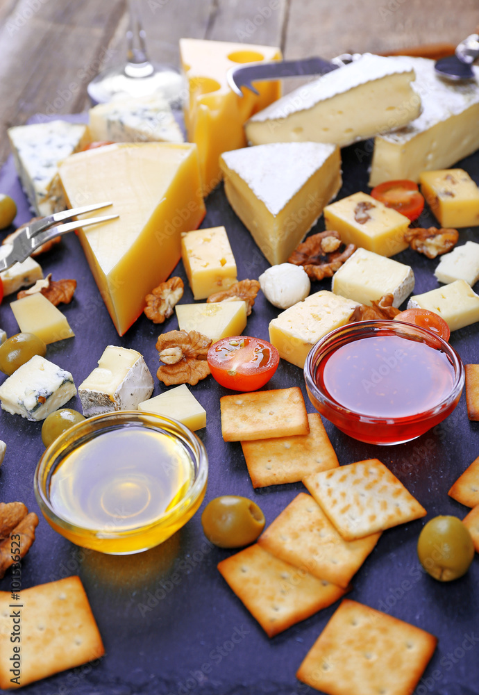 Cheese for tasting on wooden table, closeup