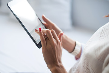 Woman using tablet computer in a coffee shop.