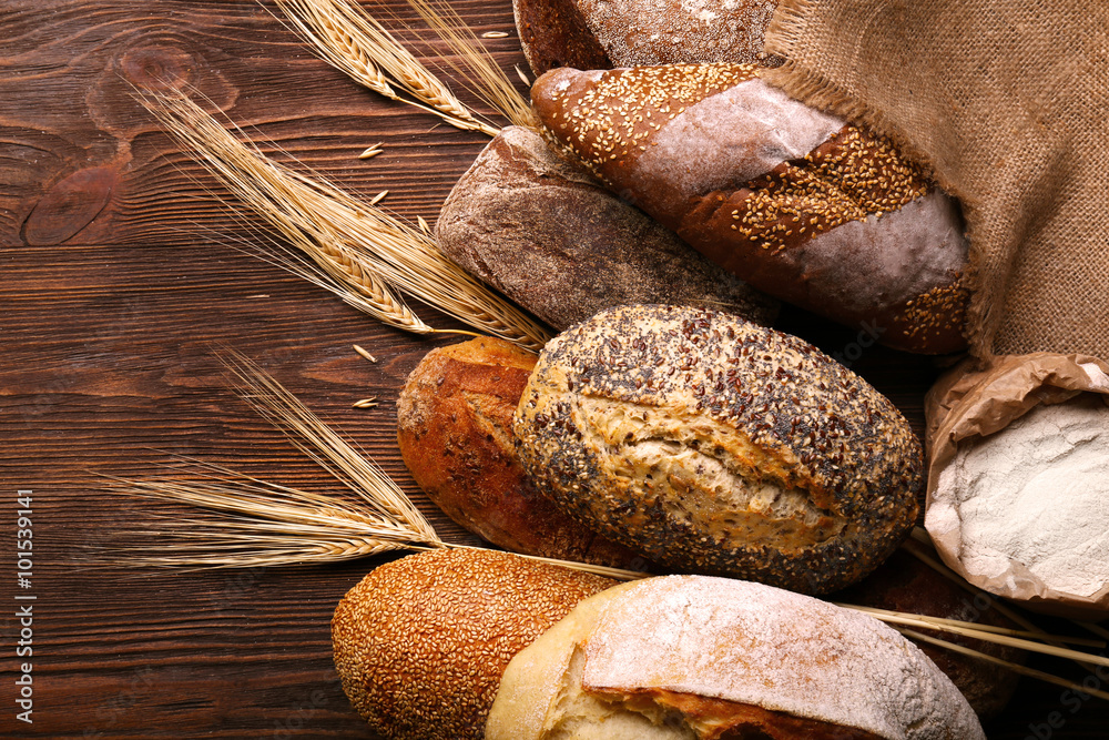 Fresh baked bread on the wooden background