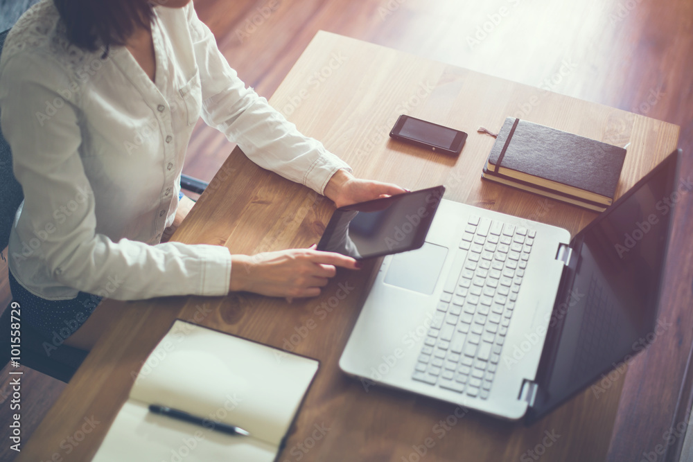 Woman using a digital tablet in office, on-line shopping at home, reading or playing.