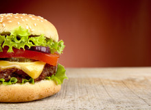 Big Cheeseburger Cropped On Red Background