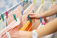 Midsection Of Woman Hands  Hanging Up Laundry