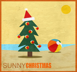 Wall Mural - sunny Christmas greeting with tree and beach ball on wood grain texture