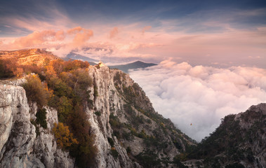 Wall Mural - beautiful landscape on the top of mountains with low clouds at sunset. nature background