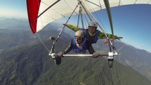 The Girl Waves Her Hands In Tandem Flight On A Hang Glider