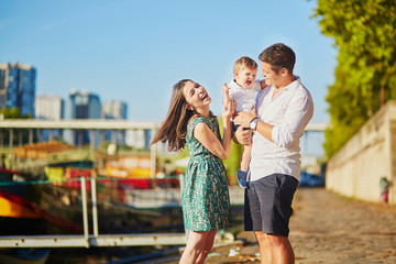 Wall Mural - Happy family of three enjoying their vacation in Paris