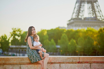 Wall Mural - Beautiful young mother with her adorable in Paris, France