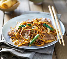 Wall Mural - chinese food - beef lo mein on a plate with chopsticks