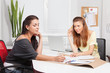 © yuro1017 - Two girls at office behind a table