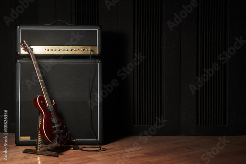 Fotografía Red electric guitar and classic amplifier on a dark background