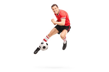 Sticker - Young football player kicking a ball