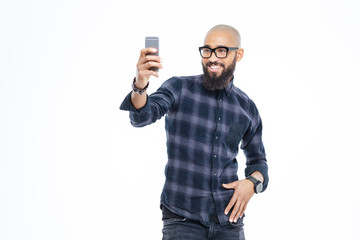 Poster - Cheerful african american man with beard smiling and taking selfie