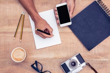 Poster - Overhead view of businessman writing on notepad