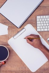 Poster - Businessman writing on notebook by coffee