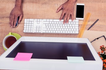 Poster - Cropped hand businessman working on computer at table