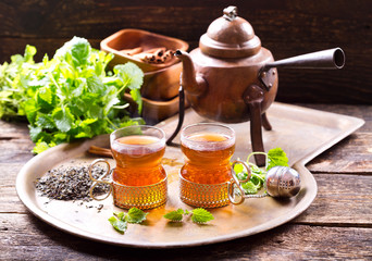 glasses of hot tea with teapot