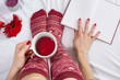 © creativefamily - Woman having a cup of tea in bed