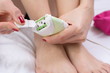 © creativefamily - Woman cleaning her epilator device