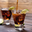 Pour the rum and cola cuba libre with lime, ice