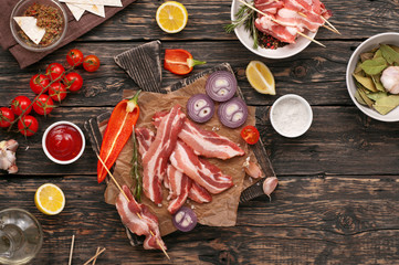 Wall Mural - Raw bacon slices with vegetables for grilling